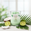 Coconut Lime candle styled scene with fresh limes, coconut and tropical leaves
