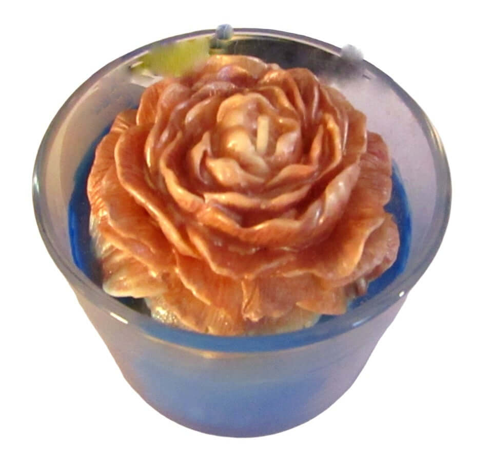 Passionfruit pineapple scented candle with a decorative flower design in a glass container.
