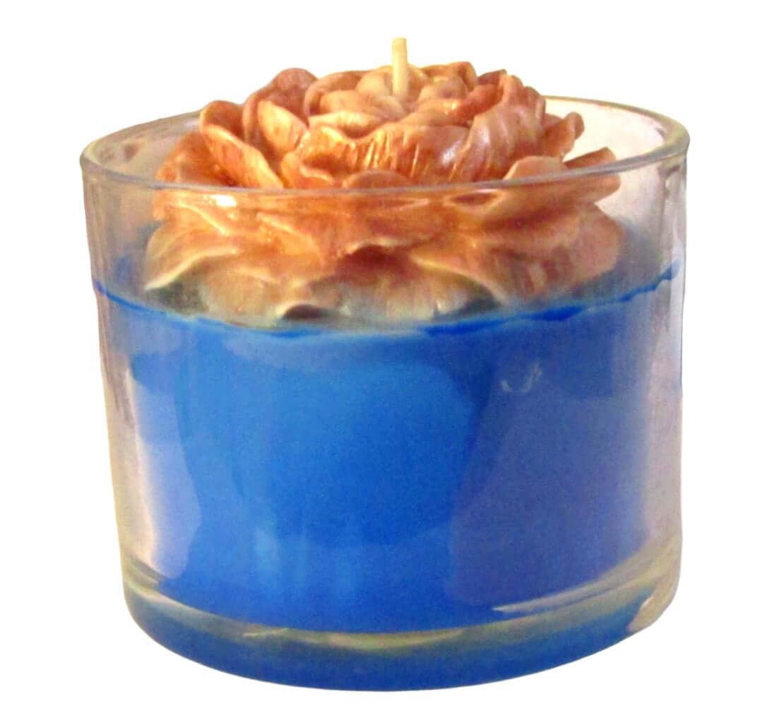 Passionfruit Pineapple scented candle with floral design in blue glass holder.